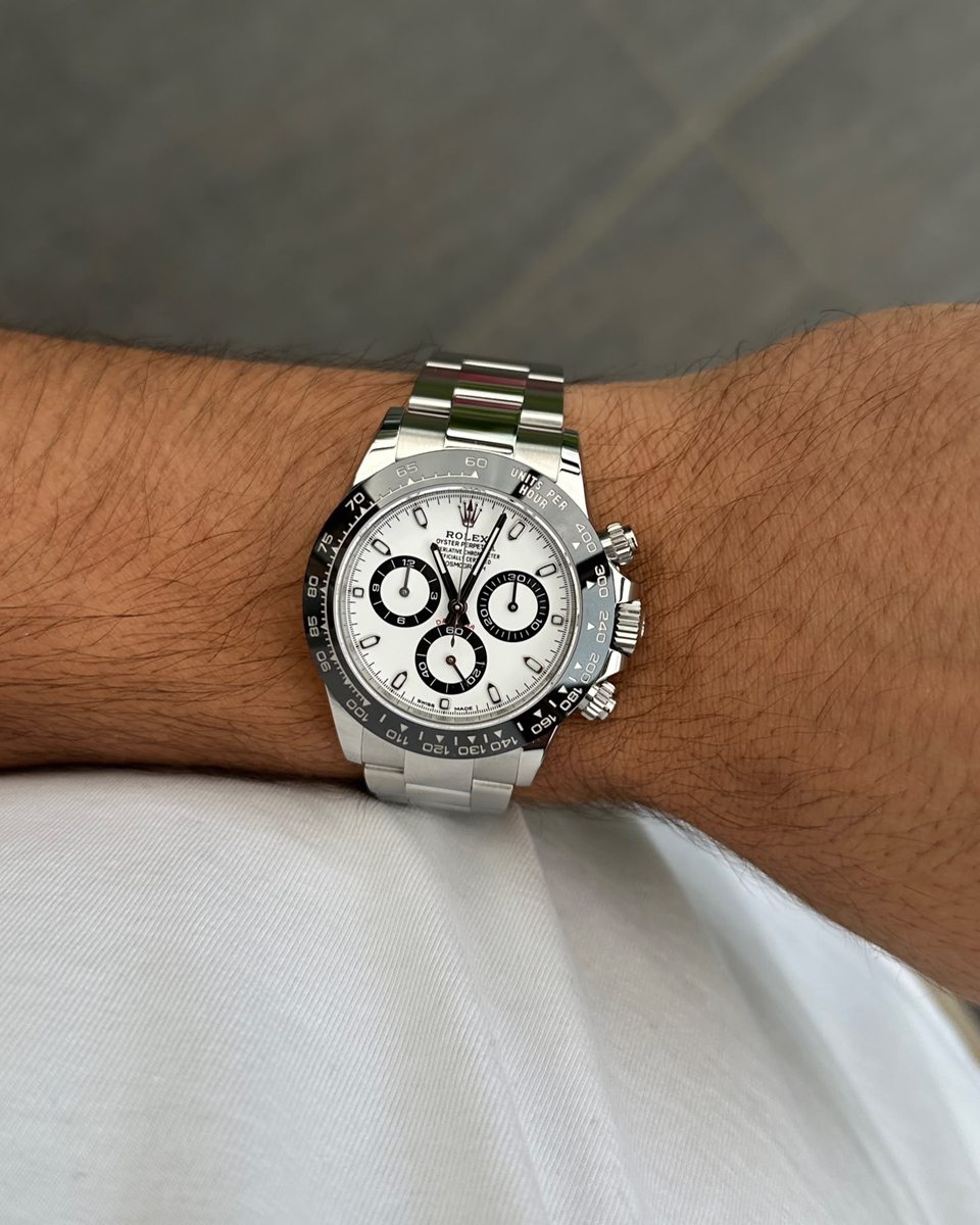 Rolex Daytona in Stahl mit weißem Zifferblatt und schwarzer Lünette am Handgelenk